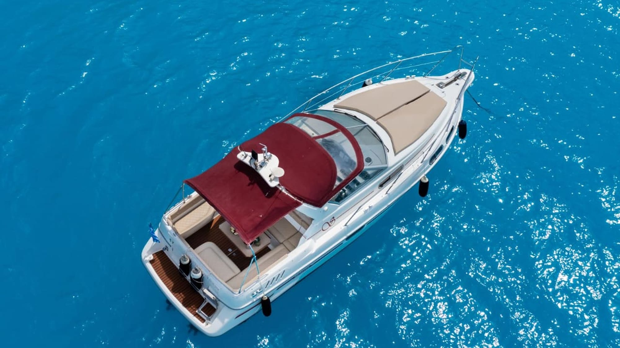 Motorboat seen from above on the blue Ionian sea